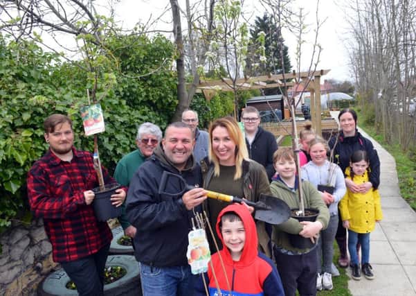 Former Blue Peter gardener Chris Collins and founder Jennie Franks (middle) with the volunteers.