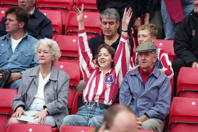 Fans in the stands at the Stadium of Light opening.
