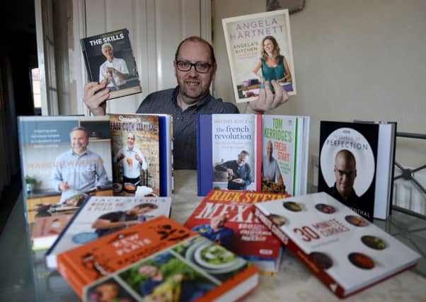 Mark Owens with a selection of cook books he is going to auction in aid of Life Kitchen.