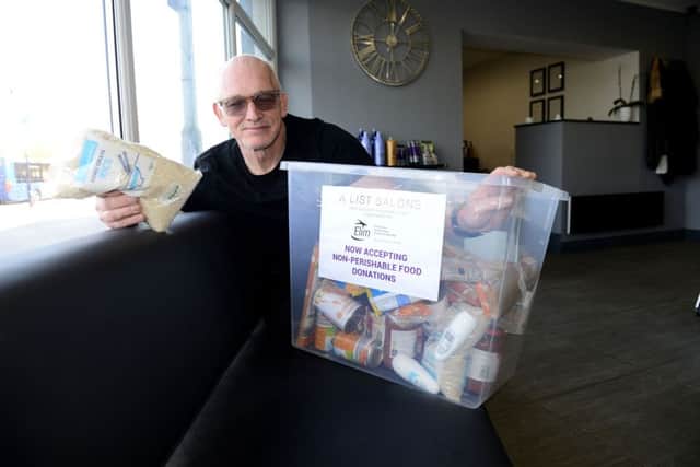 Neville Ramsay from A List Salon with one of the boxes of food items that have been donated. Picture by FRANK REID