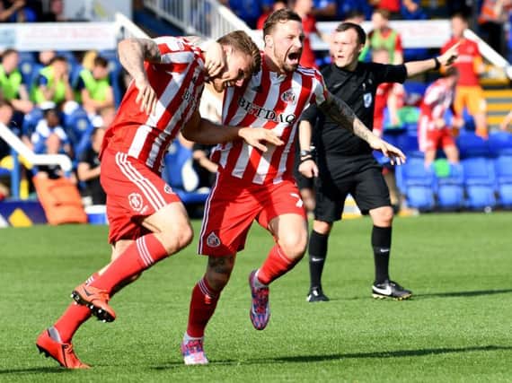 Max Power and Chris Maguire celebrate Sunderland goal at Peterborough United.