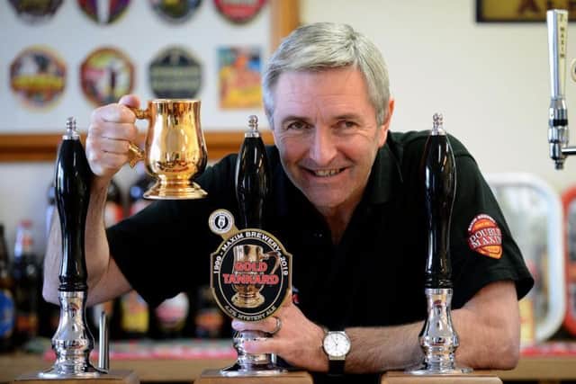 Maxim Brewery boss Mark Anderson with one of the replica gold tankards.