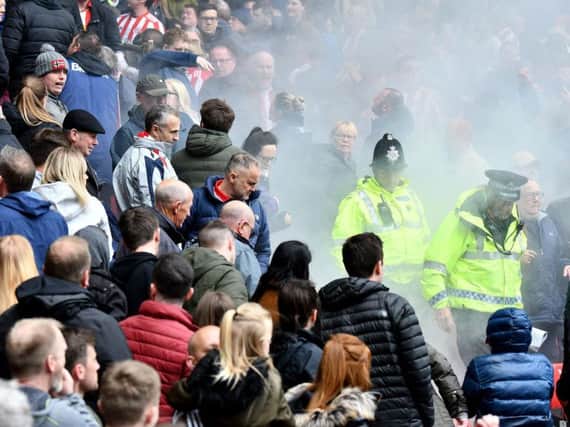 Police officers in the seats where the flare landed during the Sunderland v Portsmouth game at the Stadium of Light.