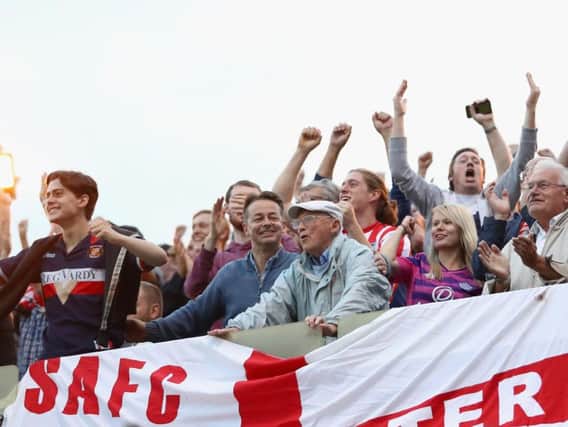 Sunderland fans celebrate their teams second goal during the Sky Bet League One match between Gillingham and Sunderland at Priestfield Stadium.