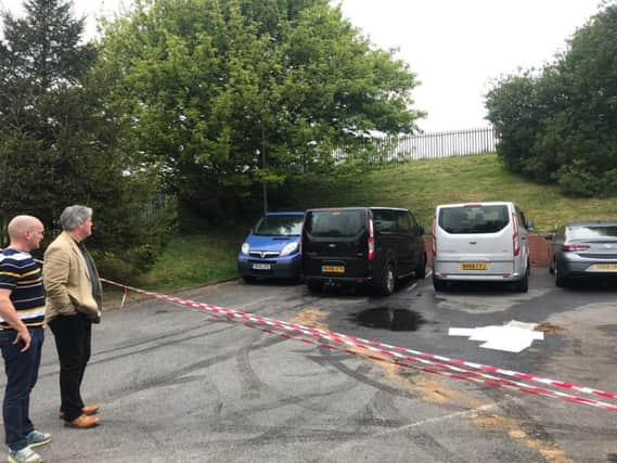 CEO John Phillipson (in beige suit jacket) looking on to the cordoned off site in Sunderland where damage was down to the charitys vehicles. John is pictured with Iain Watson, who also works for NEAS and is based at the Emsworth Site.