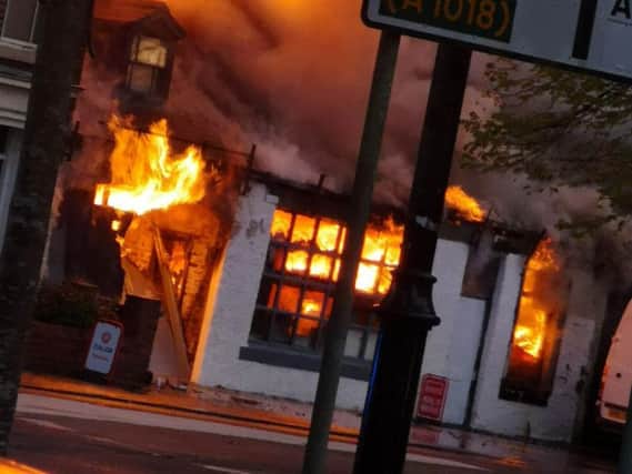 The building next door to the garage was also well alight. Pic: Jason Vasey.