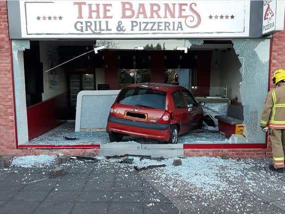 Man charged after car smashed through shop window.