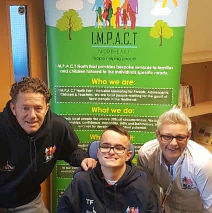 Thomas Ferry from Southwick with his dad and Lea Cole, business manager at Impact. The organisation provided equipment for him to practice and compete in sport.