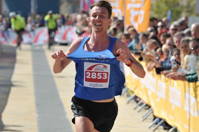 Sunderland Harrier Oliver James celebrates winning the Siglion Sunderland City 10km.