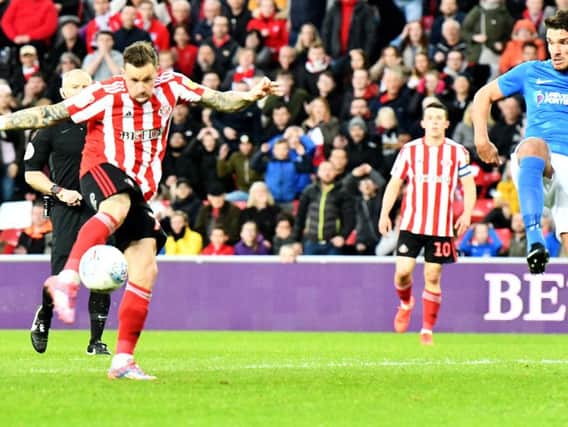 Chris Maguire volleys Sunderland ahead against Portsmouth.