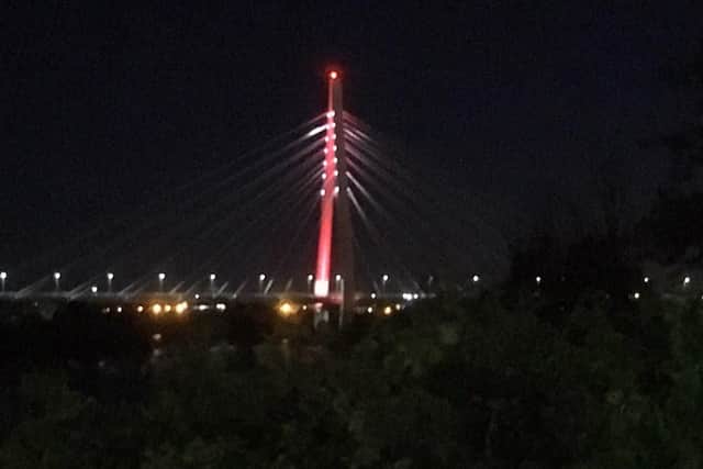 The Northern Spire Bridge lit up in red and white last night.
