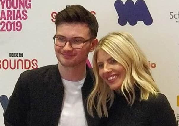 Tyler Selby pictured with Radio 1 presenter Molly King