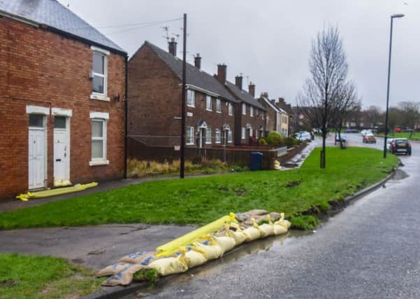 Sandbags out to help keep flooding of property to a minimum, in Market Place, Houghton,