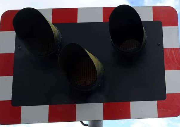 Jammed level crossing gates are causing traffic delays