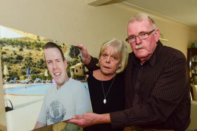 Dan and Linda Golden with a photograph of their son