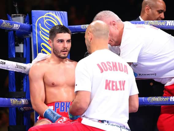 Josh Kelly with trainer Adam Booth during his majority draw with Ray Robinson (Matchroom).