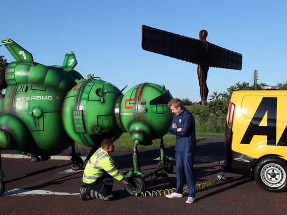AA mechanic George Flinton helped out Red Dwarf fan Alex Dowling, after he broke down near the Angel of the North while driving to Glasgow Comic Con. The sci-fi fan had remodelled his car to look like the shows famous Starbug spaceship at The Angel of The North, near Newcastle. Scott Heppell/PA Wire