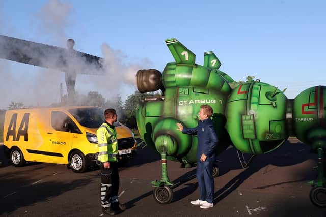 AA mechanic George Flinton helped out Red Dwarf fan Alex Dowling, after he broke down near the Angel of the North while driving to Glasgow Comic Con. The sci-fi fan had remodelled his car to look like the shows famous Starbug spaceship at The Angel of The North, near Newcastle. Scott Heppell/PA Wire