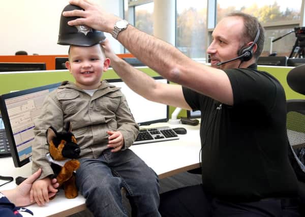 Oliver Embleton, three, a quick-thinking toddler who rang 999 after his mother collapsed visiting a police headquarters to meet call handler Michael Walton who took his call. PRESS ASSOCIATION Photo. Picture date: Wednesday November 5, 2014. Oliver was just two when mother Nicola collapsed at home from low blood pressure. But he remembered what she had taught him and rang the police, saying "Mummy fell down", and then stayed on the phone for 20 minutes until emergency services arrived. See PA story POLICE Toddler. Photo credit should read: PA Wire