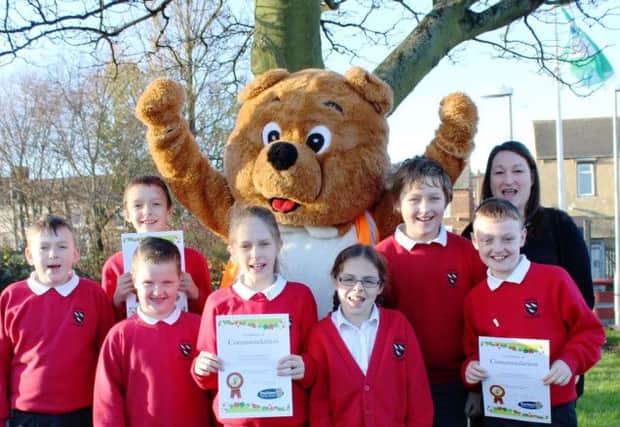 TEAM EFFORT: Tidy Ted pictured with Cotsford Junior School teacher Pauline Evans, who runs the school Eco Club, and members of the Eco Team.