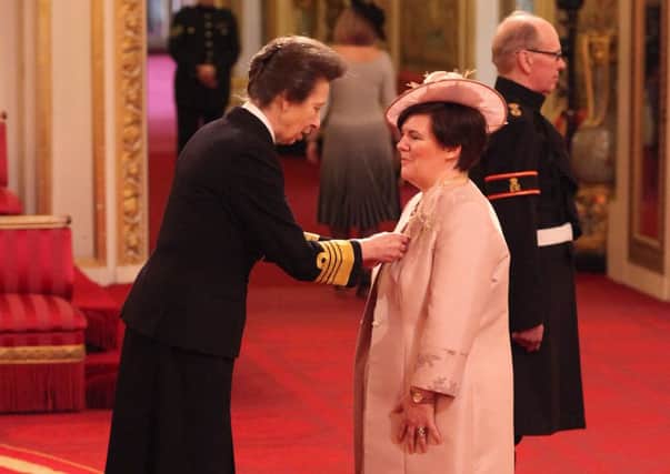 HONOURED GUEST: Caroline Gitsham receives her MBE from the Princess Royal.
