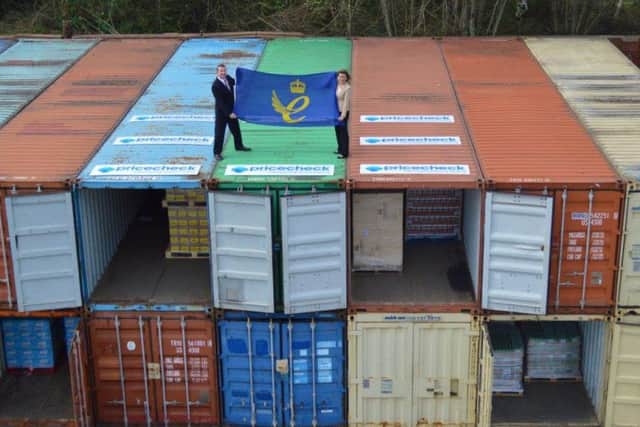 Mark Lythe and Debbie Harrison of Pricecheck Toiletries on shipping containers in the car park at their Sheffield premises.
