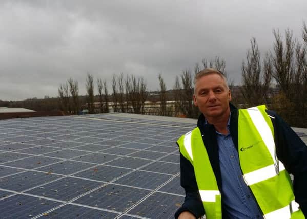Steve Walton, of Tyneside Foodservice, next to the solar photovoltaic system at the companys site.
