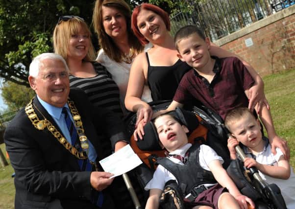 From left, Murton Parish Council chairman Coun Tom Pinkney, with  fun day organisers Sarah Vincent and Deborah Ayre,  handing over a cheque to Michael Mason and his mum Donna, with brothers Matthew and Martin.