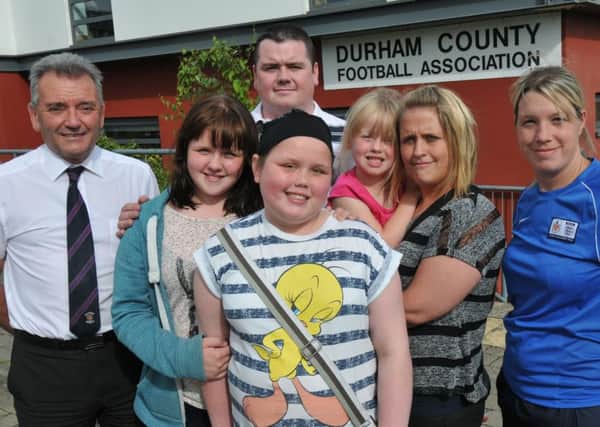Erin Bates with sisters Lauryn and Olivia, dad Simon, mum Kirsty  and John Topping and Tina Reed from Durham Football Association.