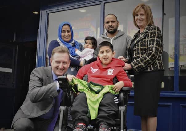 Umar receives his new powered wheelchair with Colin Johnston, left,  of Cashino, Linda Lindsay of Chips, right, parents Nazia and Hanif and sister Ravia.