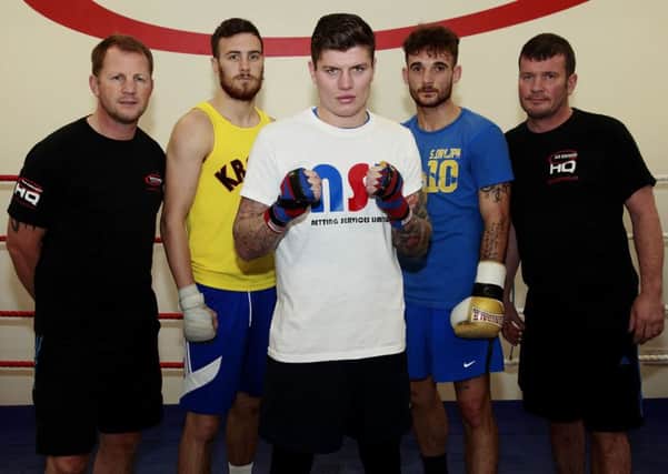 TEAM GUS: Coaches Alan Temple (left) and Peter Cope Senior (right) with Anth Hardy (23), Peter Cope Junior (24, centre) and Billy Snaith (27) at the Gus Robinson Boxing Gym Picture: DAVID WOOD