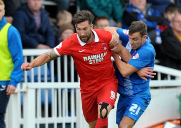 Michael Duckworth (right) tangles with Ollie Palmer in the win over Leyton Orient. Picture by FRANK REID