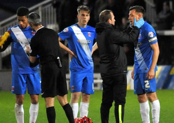 Pools skipper Carl Magnay is treated y head physio Ian Gallagher. Picture by TOM COLLINS