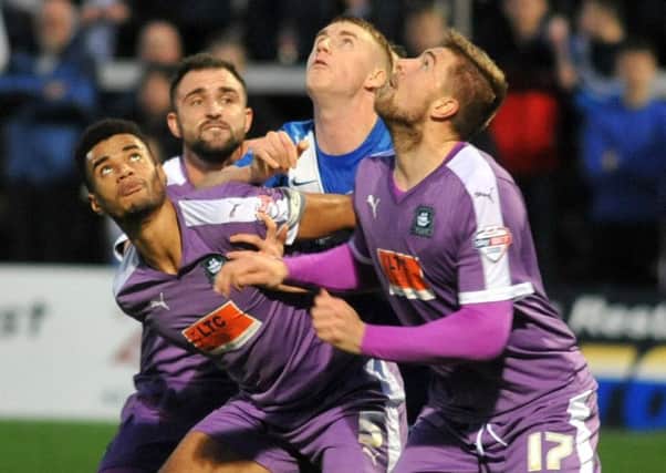 Scott Harrison is surrounded by Plymouth players Kelvin Mellor, Peter Hartley and Ryan Brunt