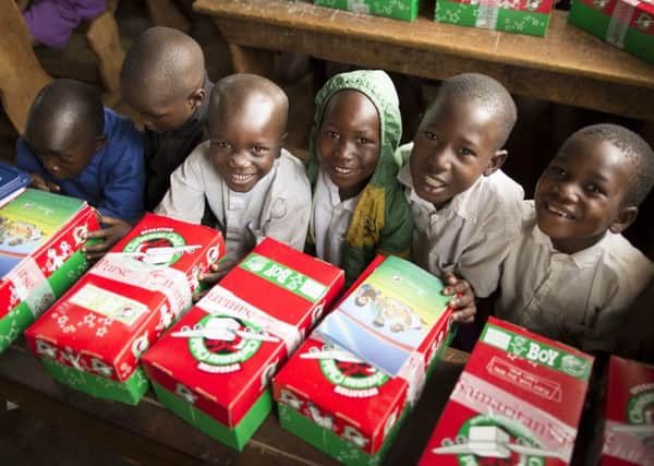 Children in Uganda receive their Christmas presents, kindly donated through the Operation Christmas Child appeal.