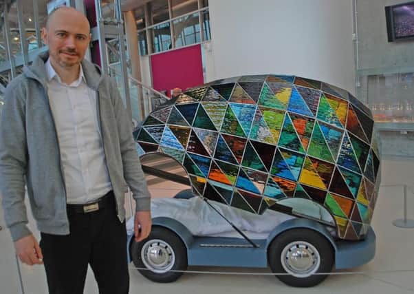 Dominic Wilcox with his driverless car, which has gone on display at the National Glass Centre.