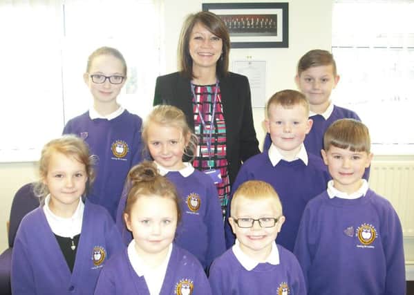 Jane Walton, headteacher at Hasting Hill Academy, with some of the children.