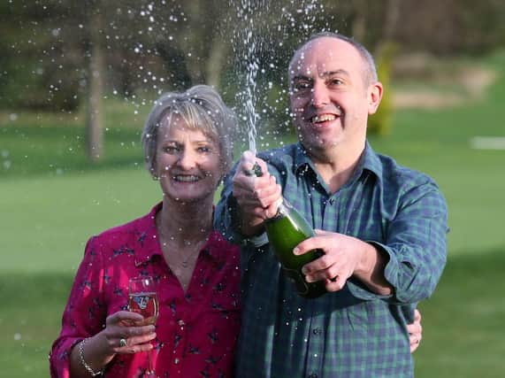Carol and David Martin celebrate their windfall at the Dalmahoy Hotel & Country Club in Edinburgh.