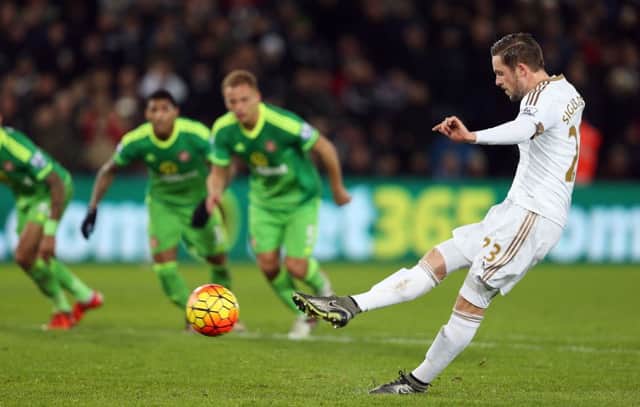 Gylfi Sigurdsson scores from a controversial penalty
