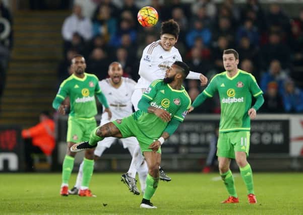 Swansea City's Ki Sung-Yueng challenges Sunderland's Jeremain Lens.