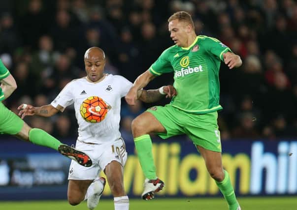 Wes Brown tackles Swansea's Andre Ayew