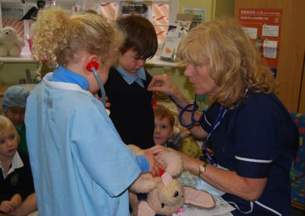 Nurse Tricia Abbott and children from Bow School.