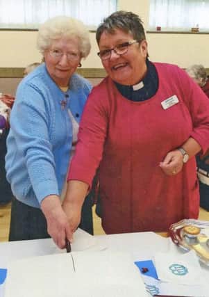 Christ Church Mother's Union leader Enid Curry and Diocesan Chaplain the Rev Val Shedden cutting the cake celebrating 120 years of Mothers' Union at Christ Church, New Seaham.