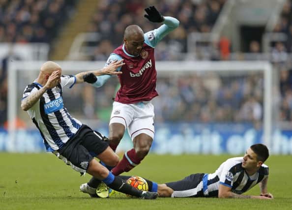 Newcastle debutant Jonjo Shelvey dives in to challenge West Ham's Angelo Ogbonna as a grounded Aleksandar Mitrovic looks on