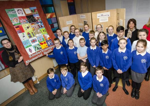 Textile artist Louise Underwood with Local Studies Manager Julie Broad and Assistant Head of Library Services Marie Brett joined children from Grangetown Primary School at the City Library and Arts Centre to view the completed Kindertransport Memorial Quilt.
