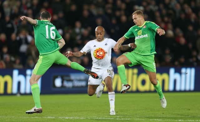 Swansea's Andre Ayew with Sunderland's John O'Shea and Wes Brown