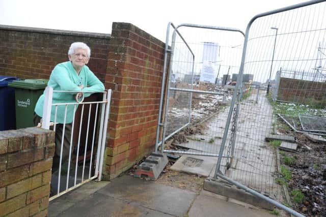 Eileen Makin with the notice asking building site workers not to spit on the pavement outside her home.
