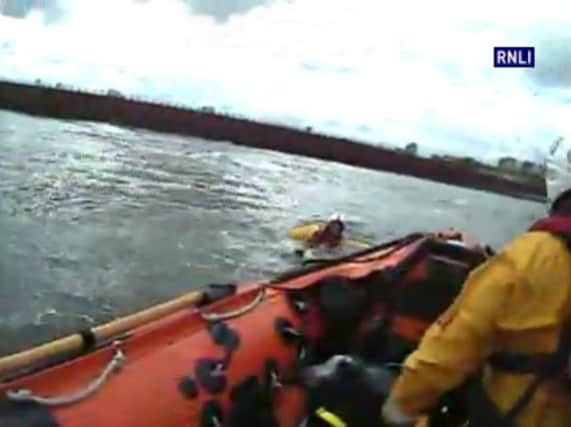 A Sunderland RNLI crew rescue a man stranded in the water off Roker Beach on September 17, 2015