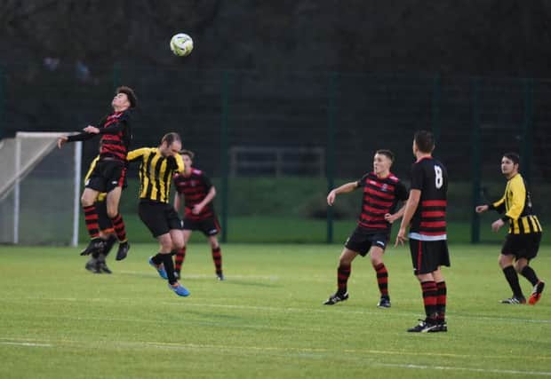 Durham City Reserves (red/black) battle Seaham New Westlea in a recent clash