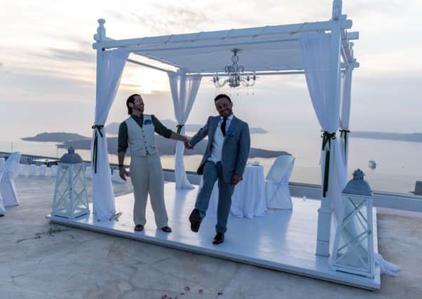 The late David Bulmer-Rizzi, left, with husband Marco as they celebrate their marriage in Santorini in Greece.